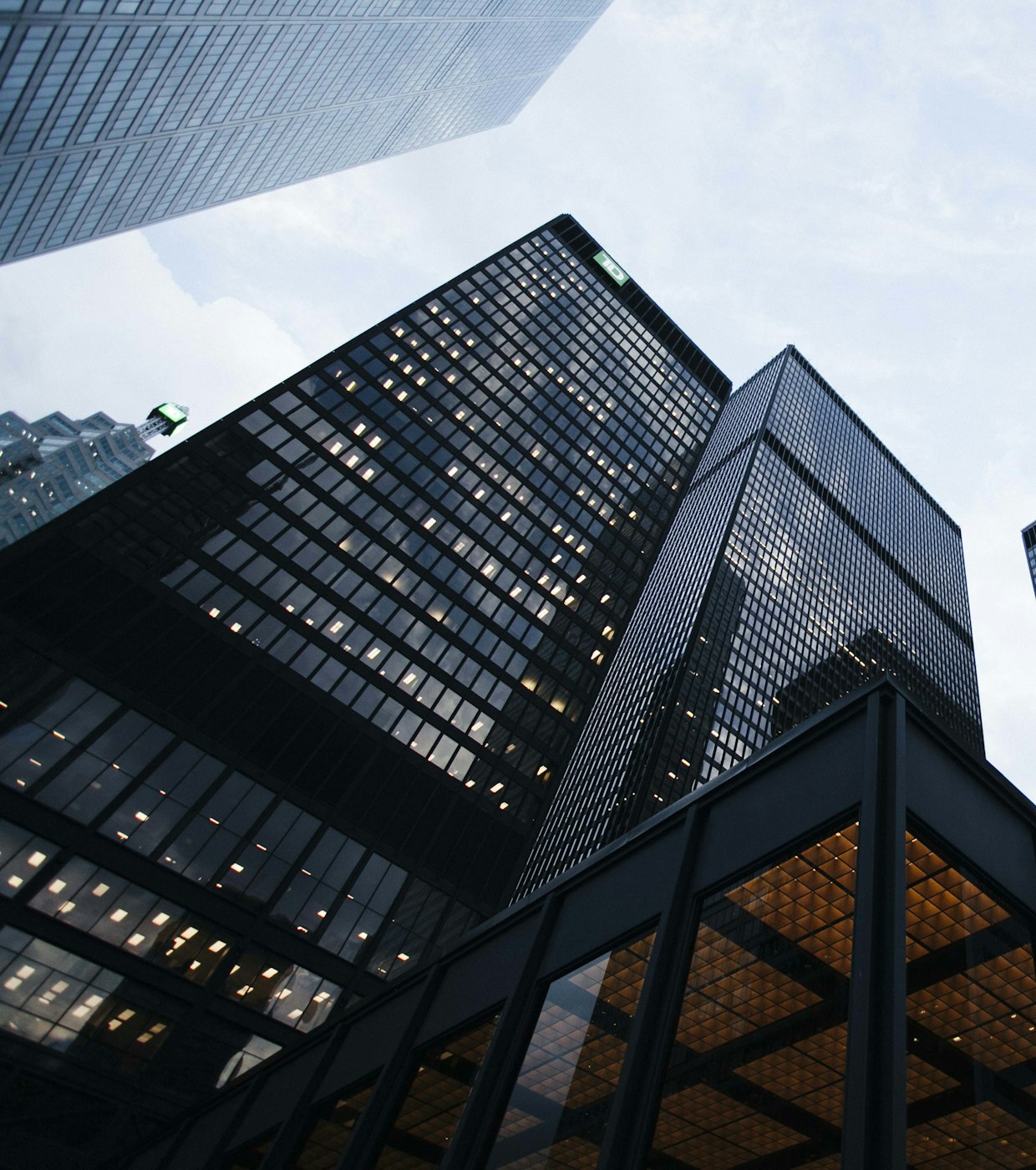Modern glass towers seen from street level at dusk